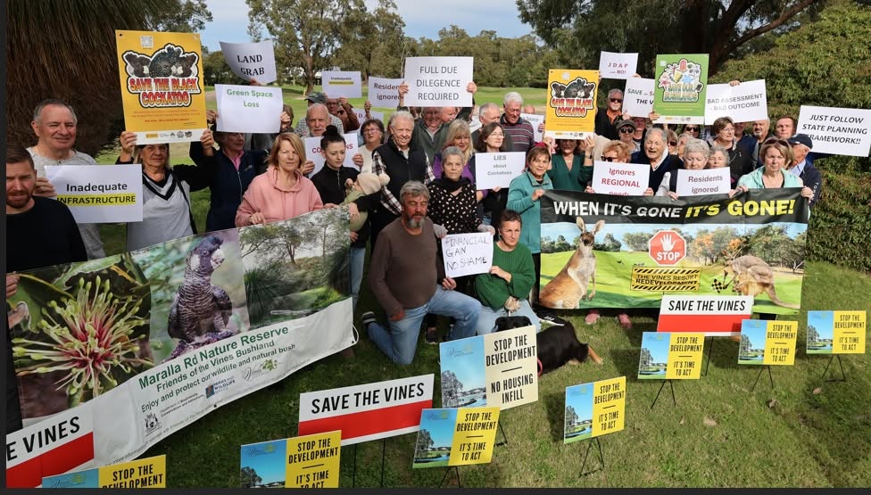 Group of The Vines Residents with messages on sign boards opposing The Vines Housing Redevelopment
